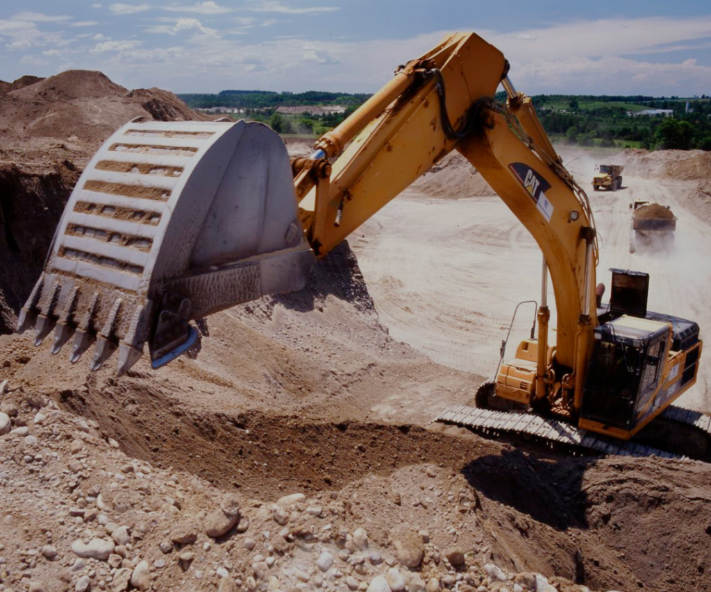 About Us Page - Excavator mining aggregate from a pile at a hertiage aggregate site